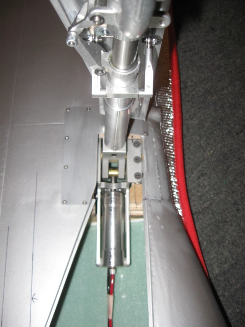 When properly setup, the collar holding the turnbuckles should be square to the door as shown here. If you are forced to skew it around to make the door fit the opening when the gear is retracted, then your hinge is likely installed wrong. 