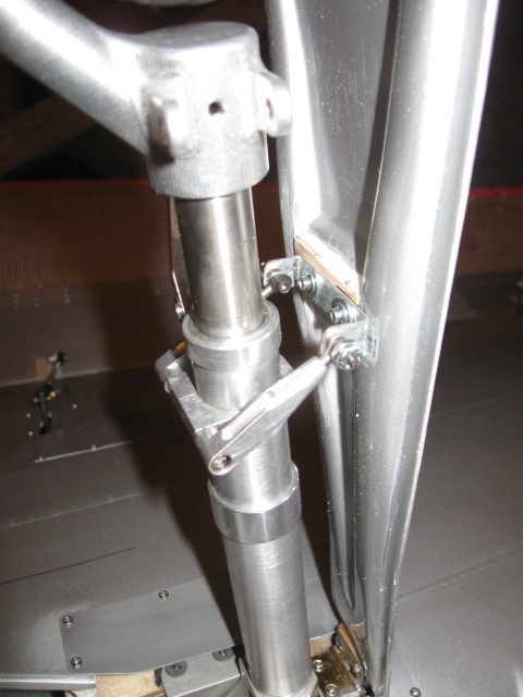 This is Sierra gear made especially for the CARF P-51 which is very scale in appearance. The turnbuckles are on the strut collar and they attach to the outer gear door to make it follow the strut as it extends and retracts. The outer door needs some plywood to attach the steel bracket to as the composite door is too thin to support any screws. Fine tuning this set of turnbuckles is done after door is in place. It should be fairly close to a perfect fit or you are off at some point in your hinge install. 