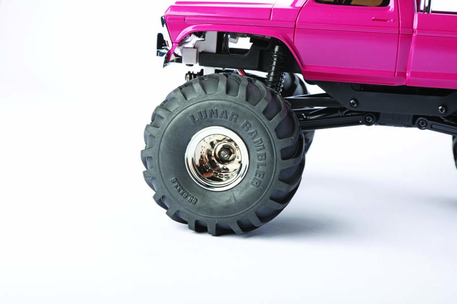 Monster truck style tires come mounted to chrome deep-dish wheels.